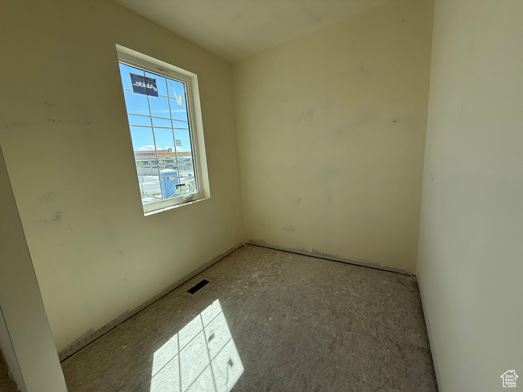 Unfurnished room featuring visible vents