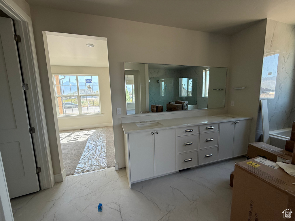 Full bath with vanity, marble finish flooring, and a marble finish shower