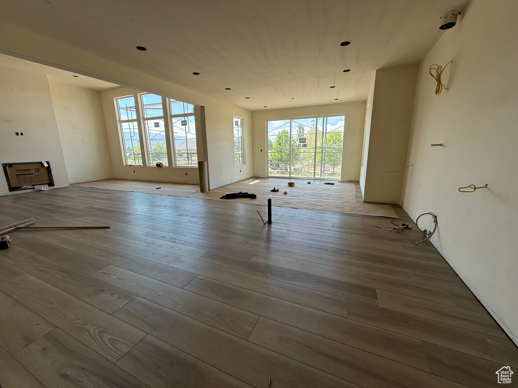 Unfurnished living room featuring wood finished floors