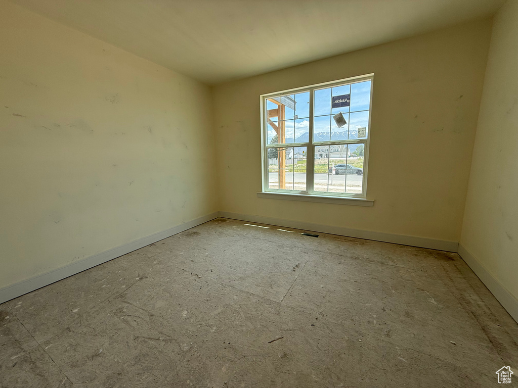 Unfurnished room featuring baseboards