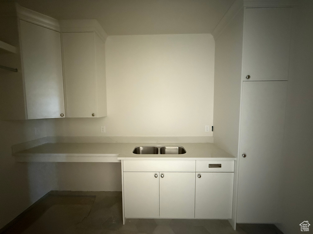 Kitchen featuring light countertops and white cabinets