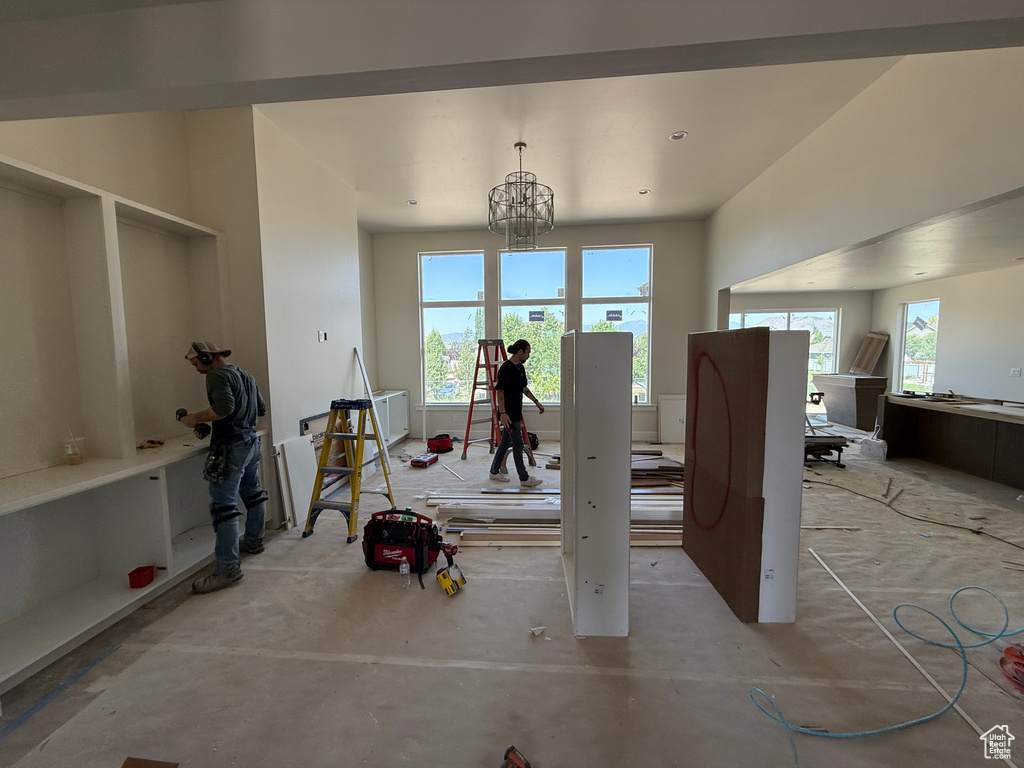 Dining room featuring a chandelier and unfinished concrete floors