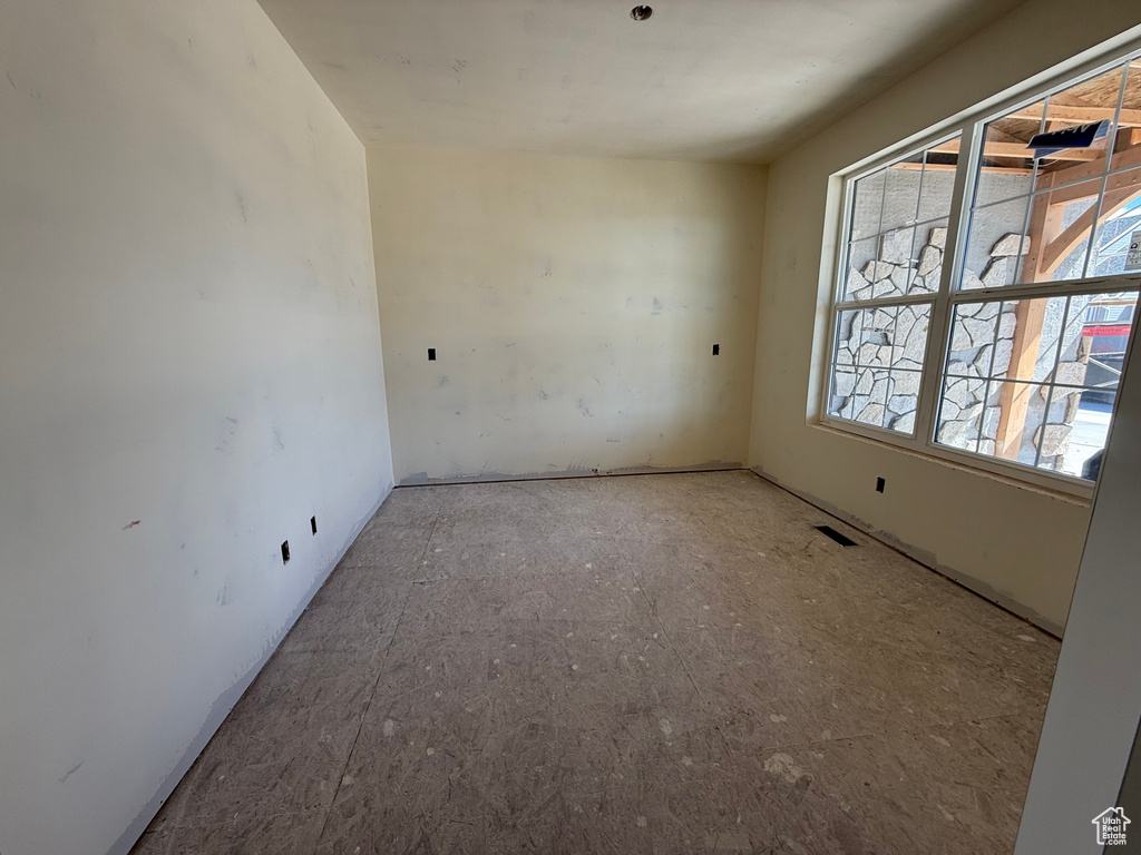 Unfurnished room featuring visible vents