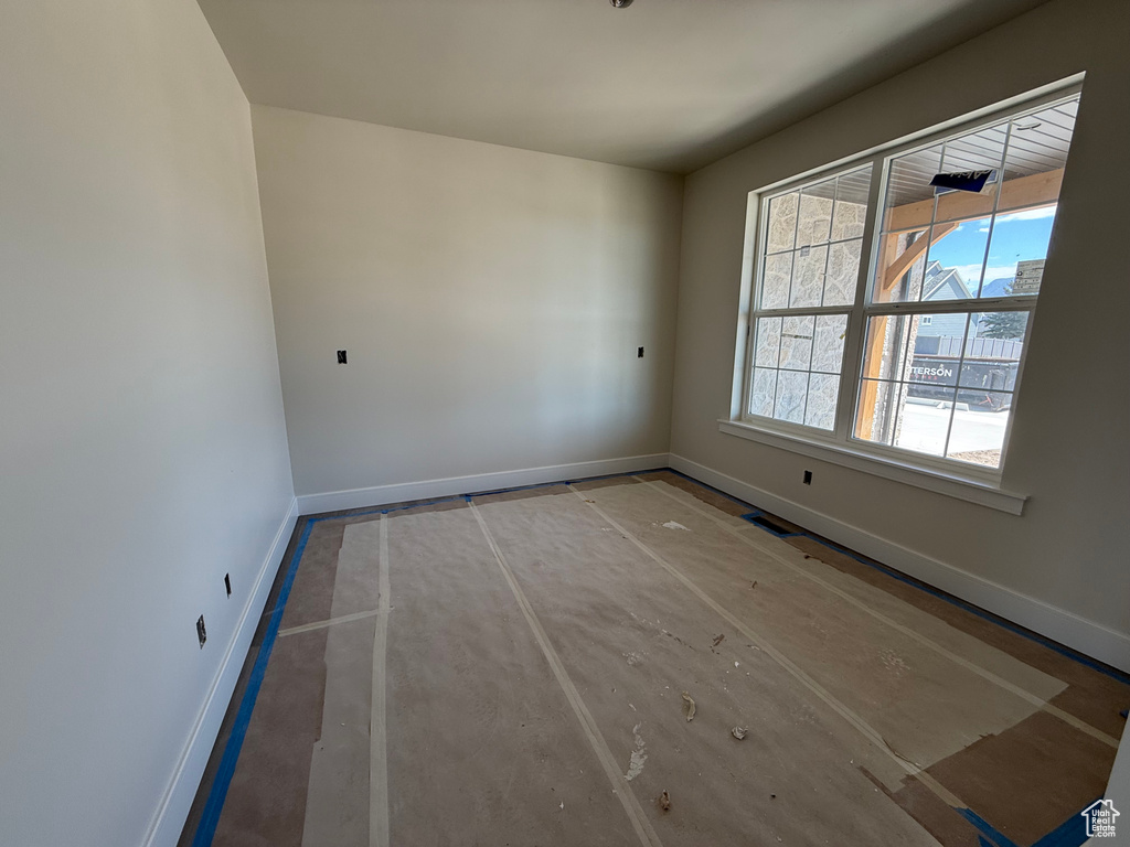 Unfurnished room with baseboards