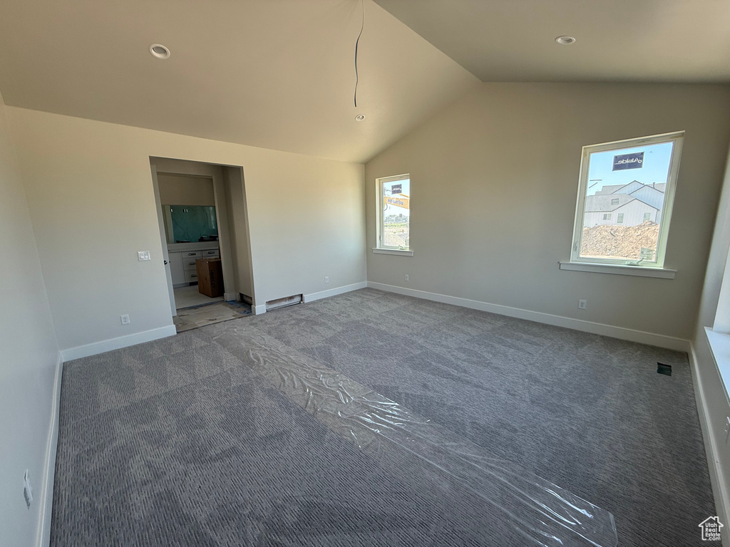 Unfurnished bedroom with lofted ceiling, carpet, and recessed lighting
