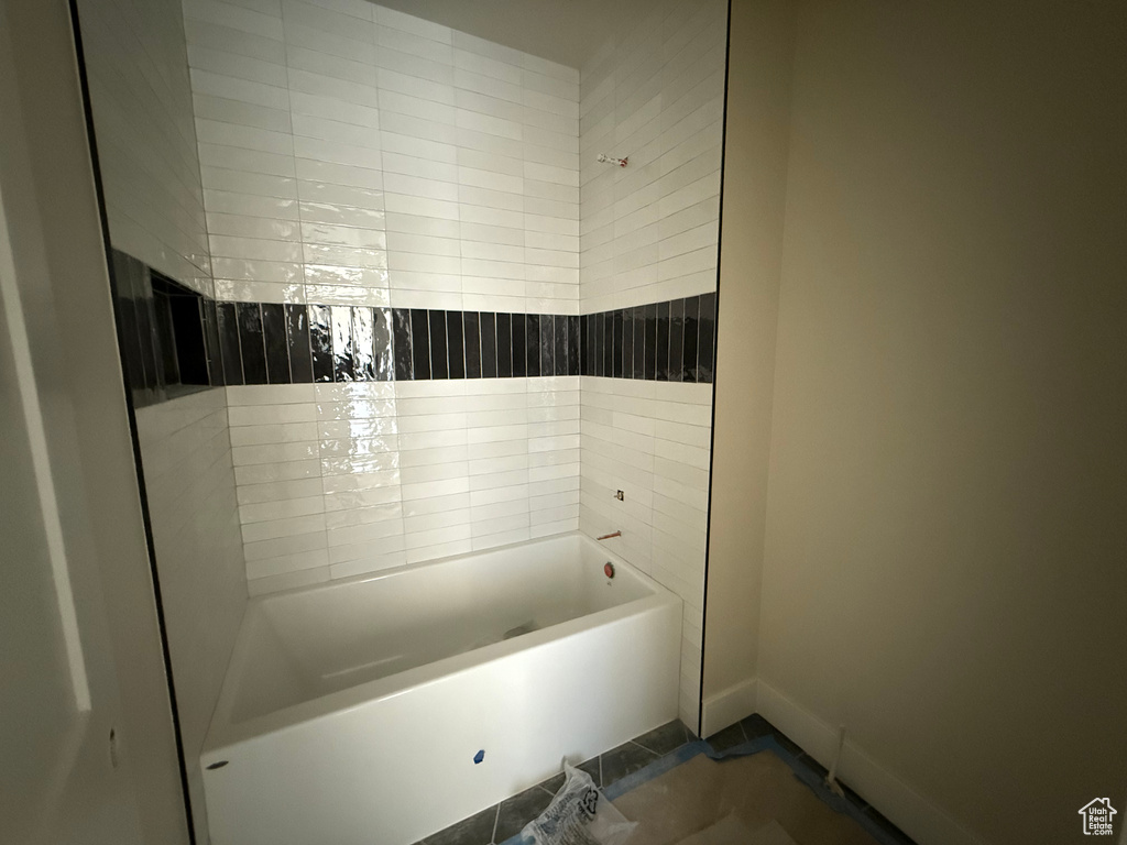 Bathroom featuring baseboards and shower / bathtub combination