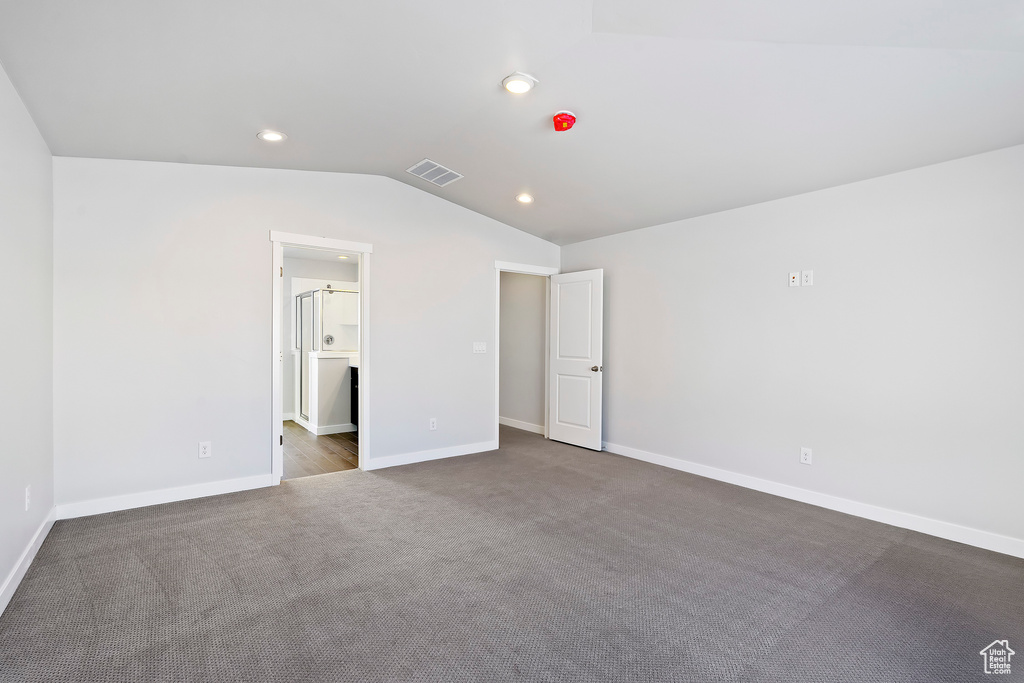 Unfurnished bedroom featuring baseboards, recessed lighting, carpet flooring, visible vents, and lofted ceiling