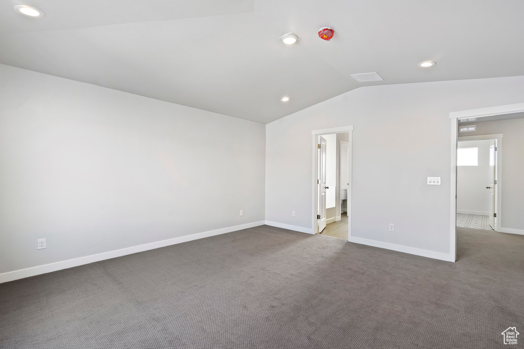 Unfurnished room featuring baseboards, vaulted ceiling, recessed lighting, carpet flooring, and visible vents