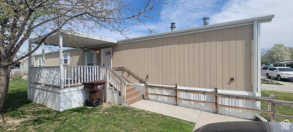 Back of house featuring a lawn