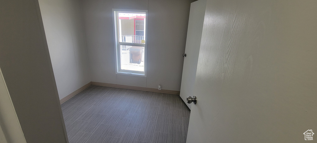 Spare room with baseboards and a healthy amount of sunlight