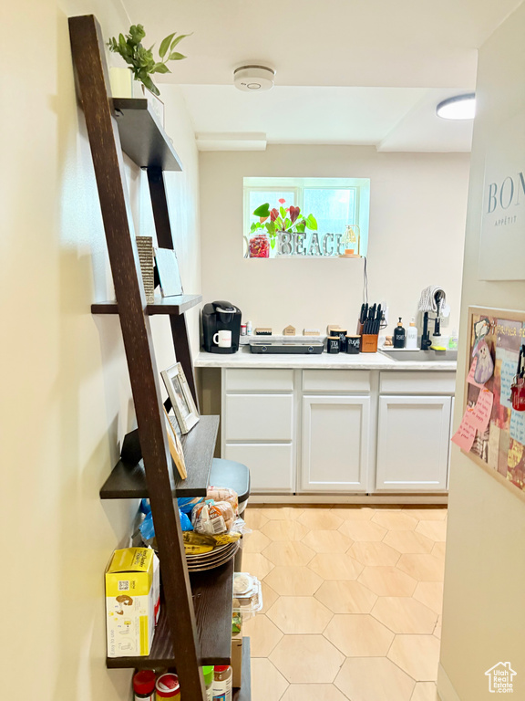 Interior space with white cabinets and light countertops
