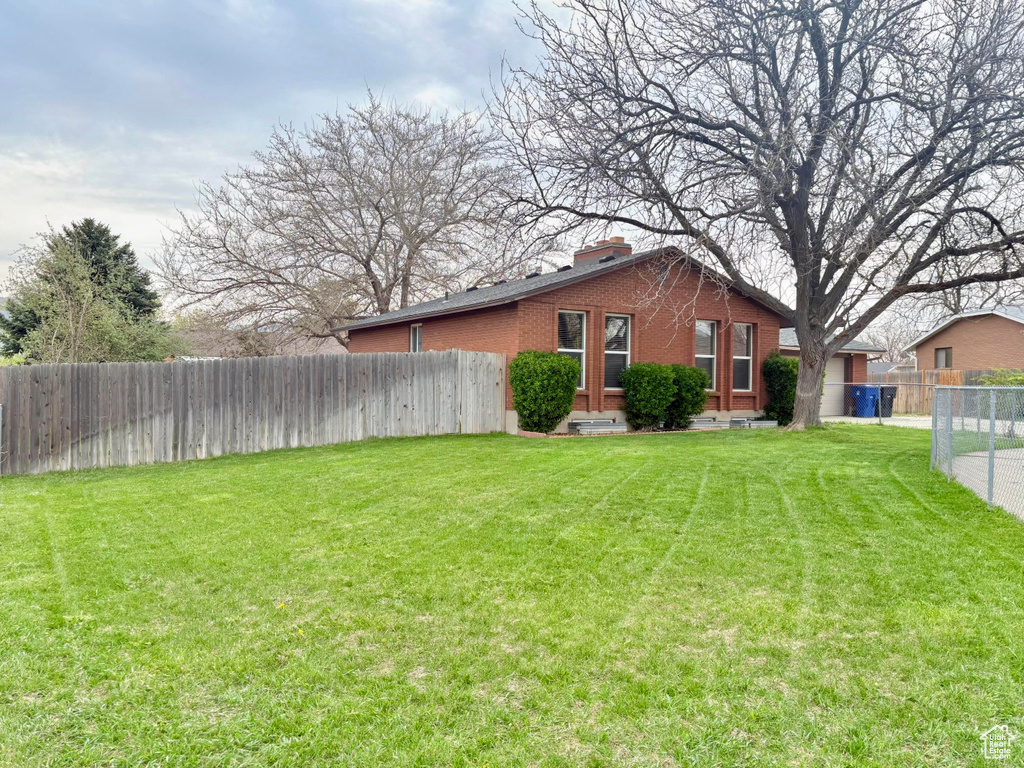 View of yard featuring fence