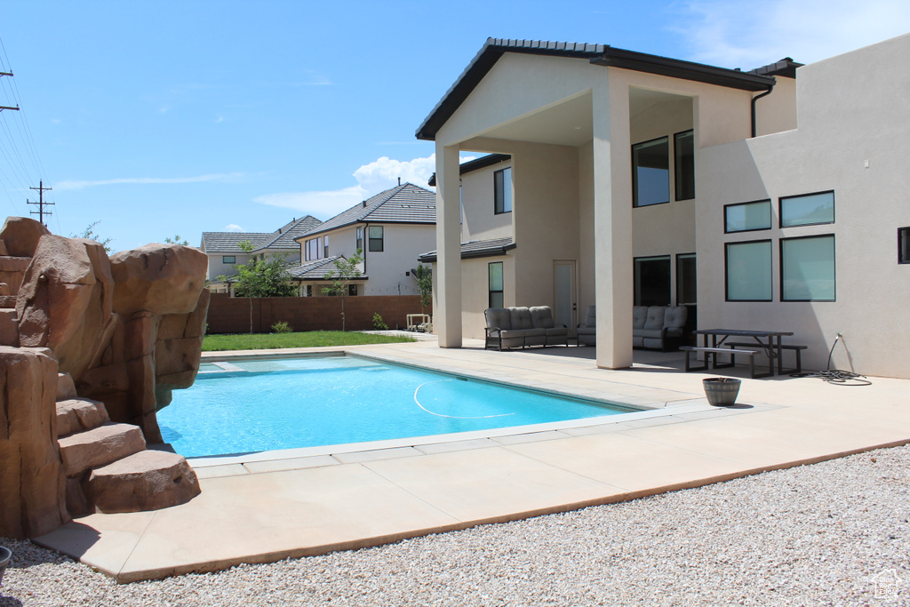 View of swimming pool with outdoor lounge area, a patio area, and a fenced backyard
