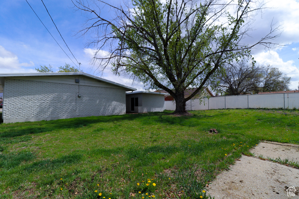 View of yard featuring fence
