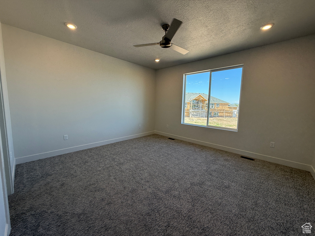 Spare room featuring a ceiling fan, baseboards, carpet floors, recessed lighting, and a textured ceiling