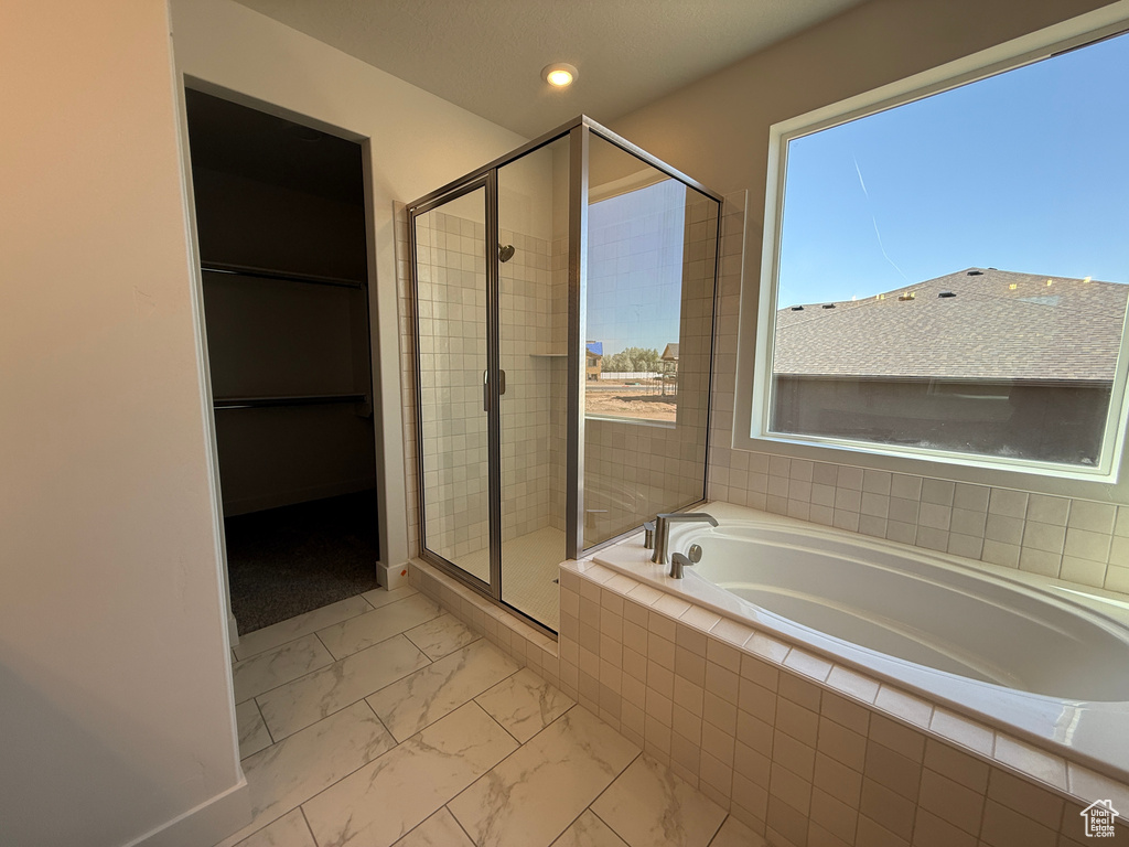 Bathroom with a stall shower, marble finish floors, a garden tub, recessed lighting, and baseboards