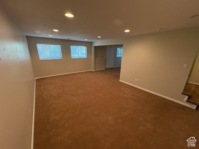 Carpeted spare room featuring recessed lighting and baseboards