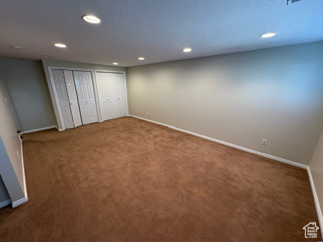 Unfurnished bedroom featuring multiple closets, recessed lighting, carpet, and baseboards