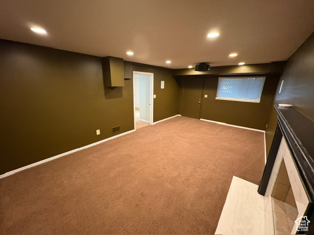Finished basement with recessed lighting, light carpet, and baseboards