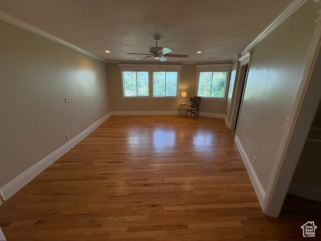 Unfurnished room with crown molding, ceiling fan, light wood-style floors, baseboards, and recessed lighting