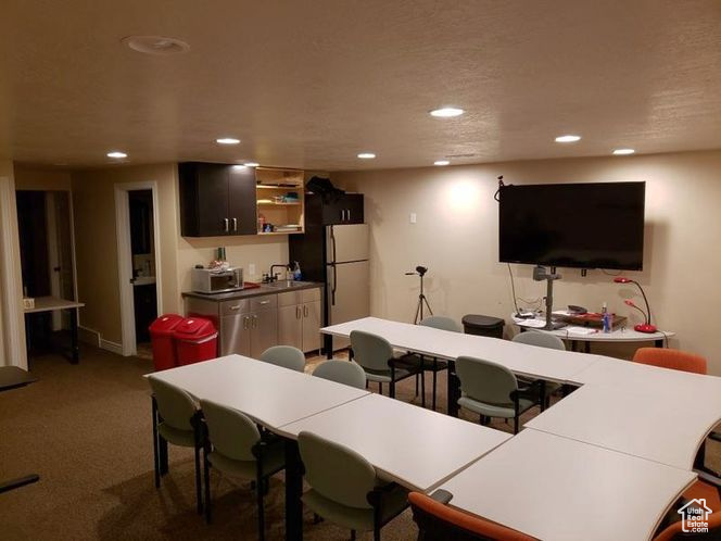 Interior space featuring recessed lighting, carpet flooring, and open shelves
