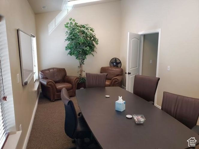 Dining space featuring carpet and baseboards