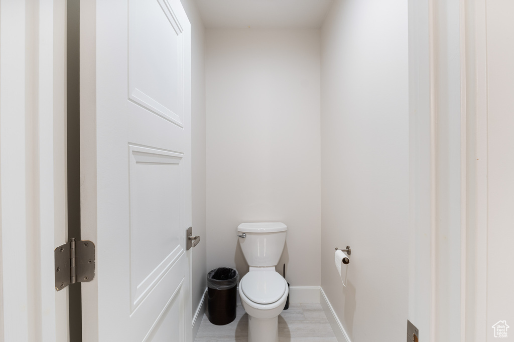 Bathroom featuring baseboards and toilet