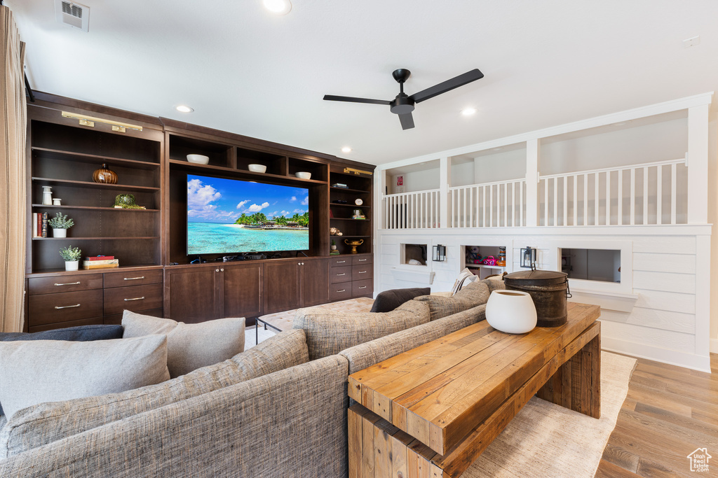 Cinema with a ceiling fan, light wood-style floors, visible vents, and recessed lighting