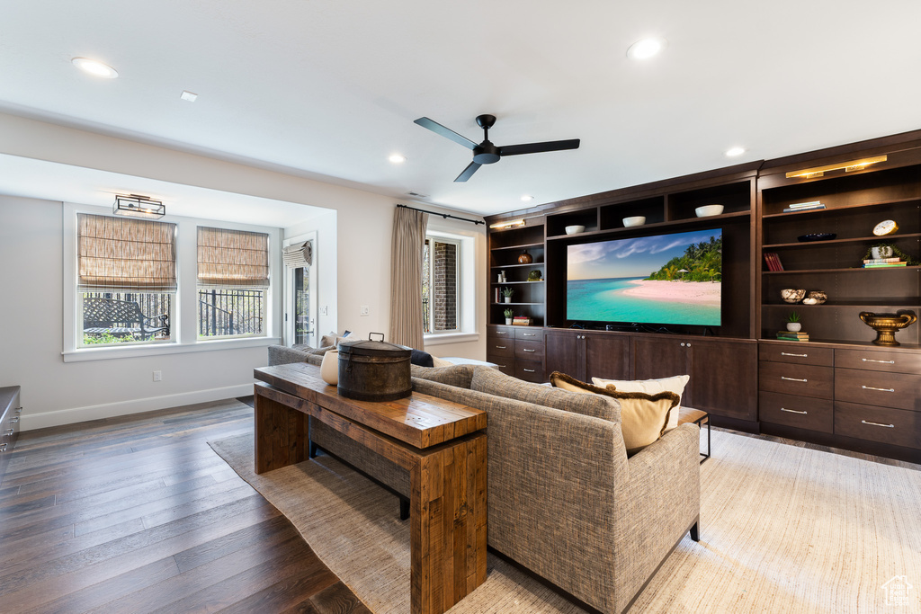 Living room with light wood-type flooring, baseboards, recessed lighting, and ceiling fan