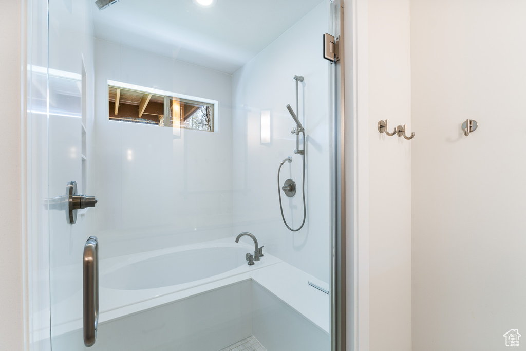 Full bathroom featuring a bath and a shower