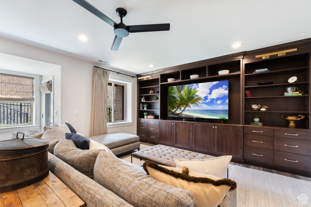 Living room featuring light wood-type flooring, visible vents, recessed lighting, and ceiling fan