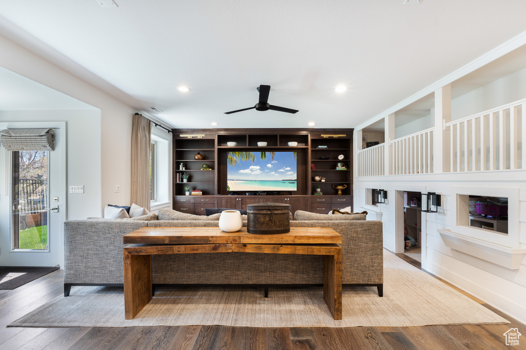 Living room with wood finished floors, recessed lighting, and ceiling fan