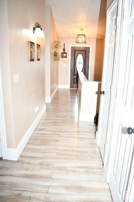 Hall featuring light wood-style floors and baseboards