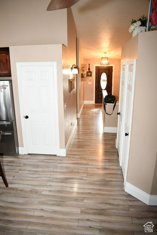 Foyer entrance with light wood finished floors and baseboards