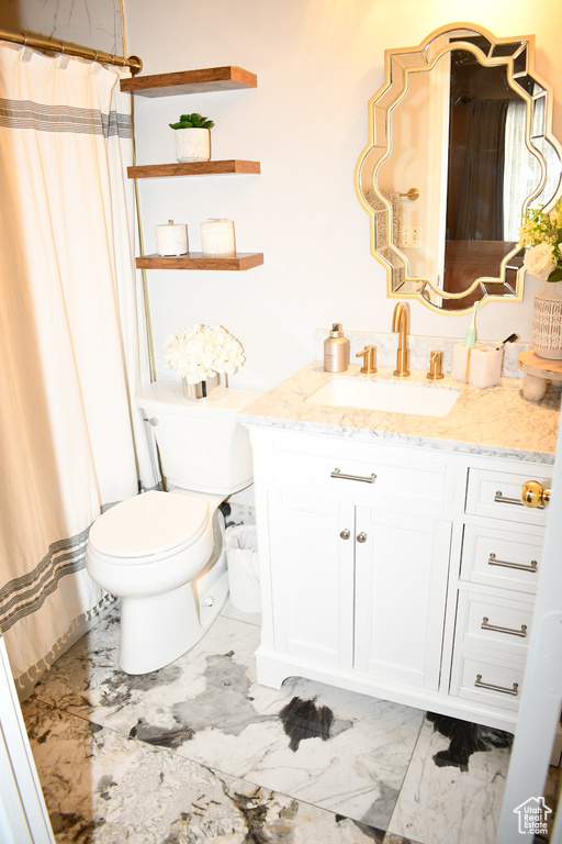 Full bathroom with curtained shower, vanity, marble finish floor, and toilet