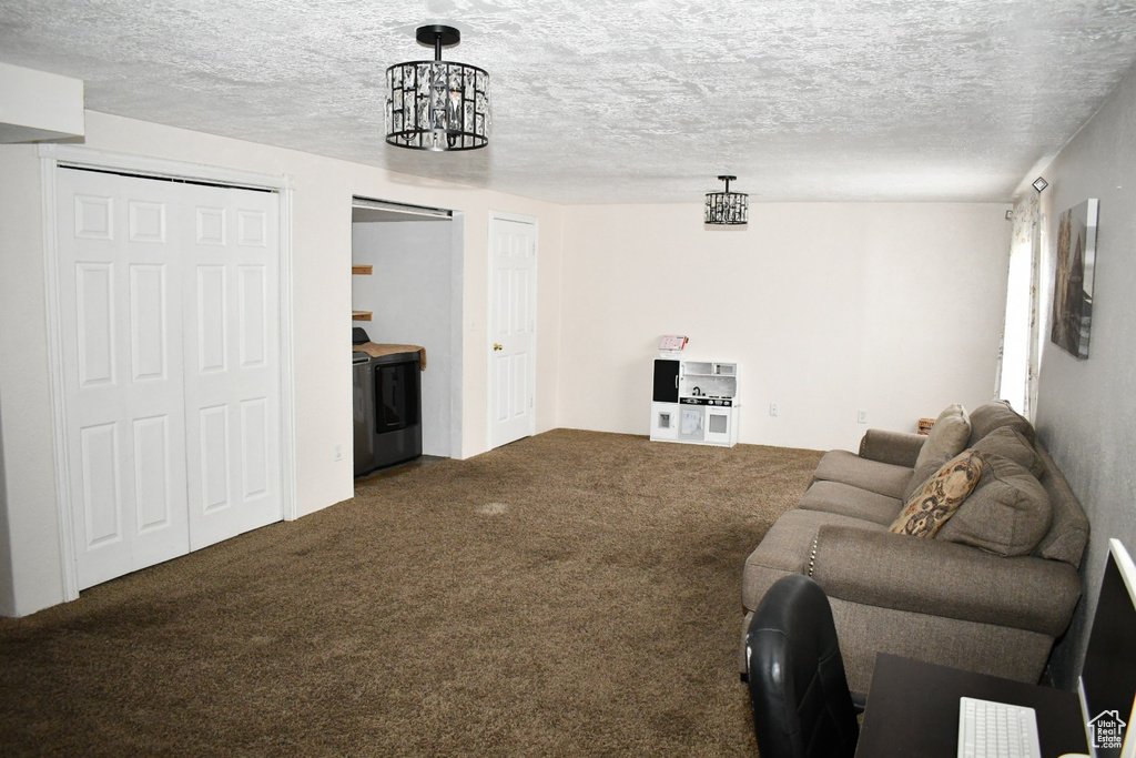 Living room with a textured ceiling and carpet floors