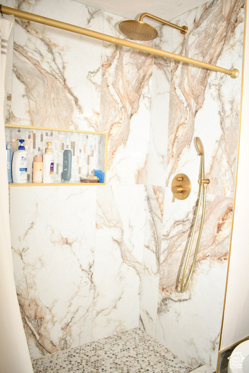 Bathroom with a marble finish shower