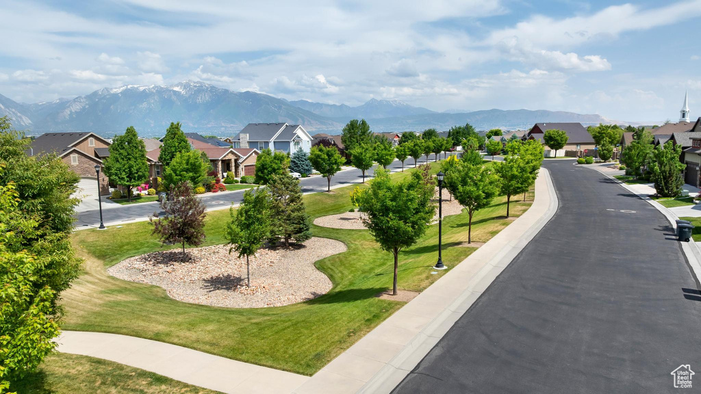 View of home\'s community featuring a residential view, a mountain view, and a yard