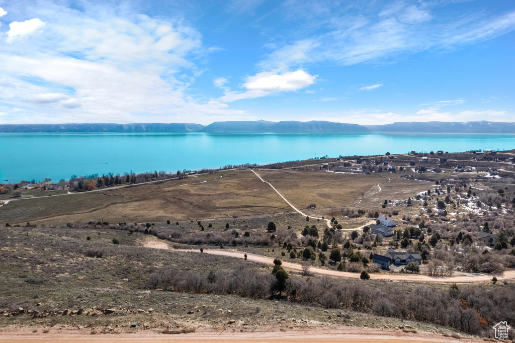 Birds eye view of property with a water and mountain view