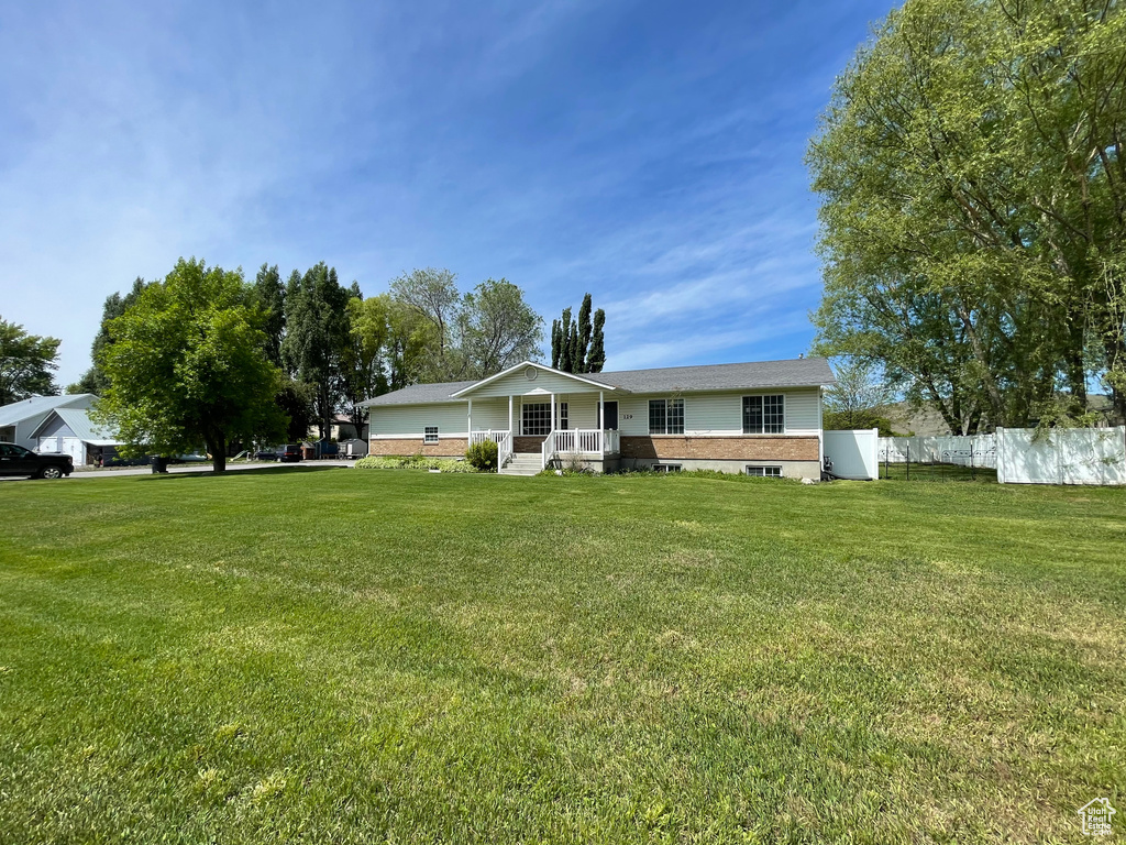 Single story home featuring covered porch