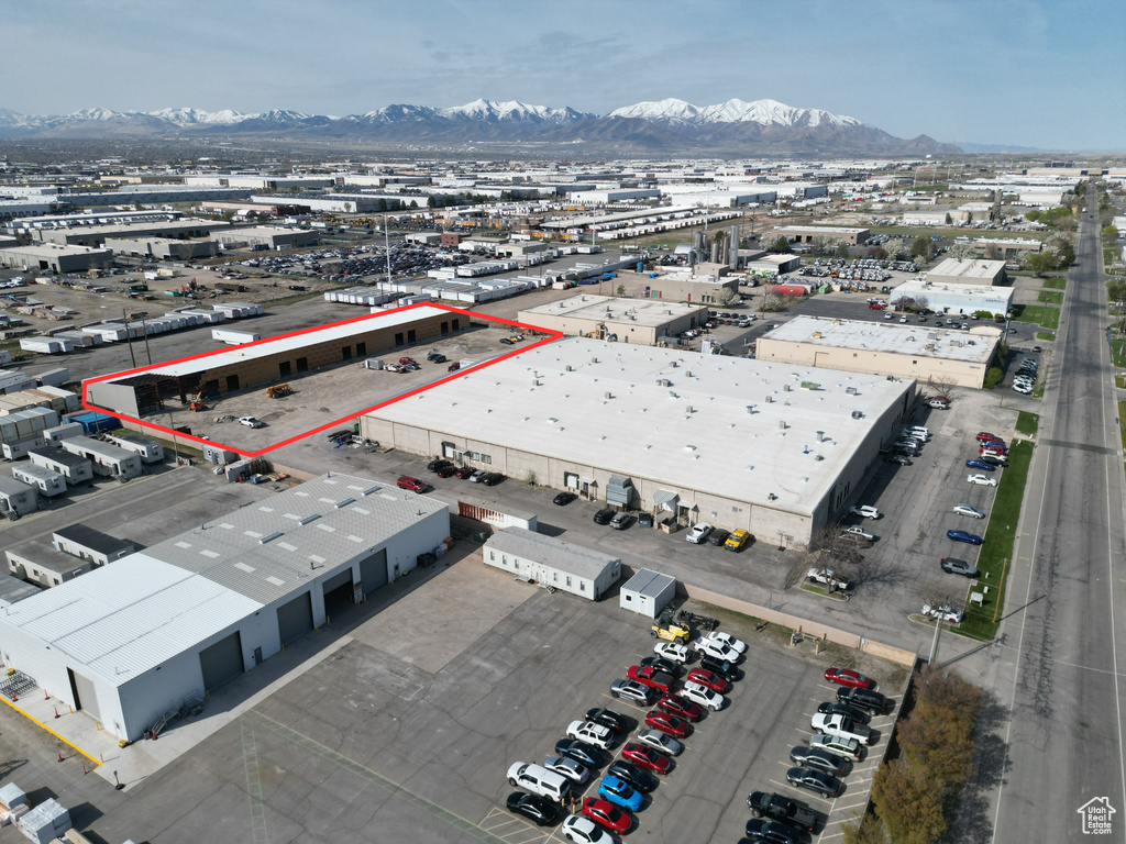 Aerial view of property\'s location with mountains, an industrial area, and property boundaries highlighted