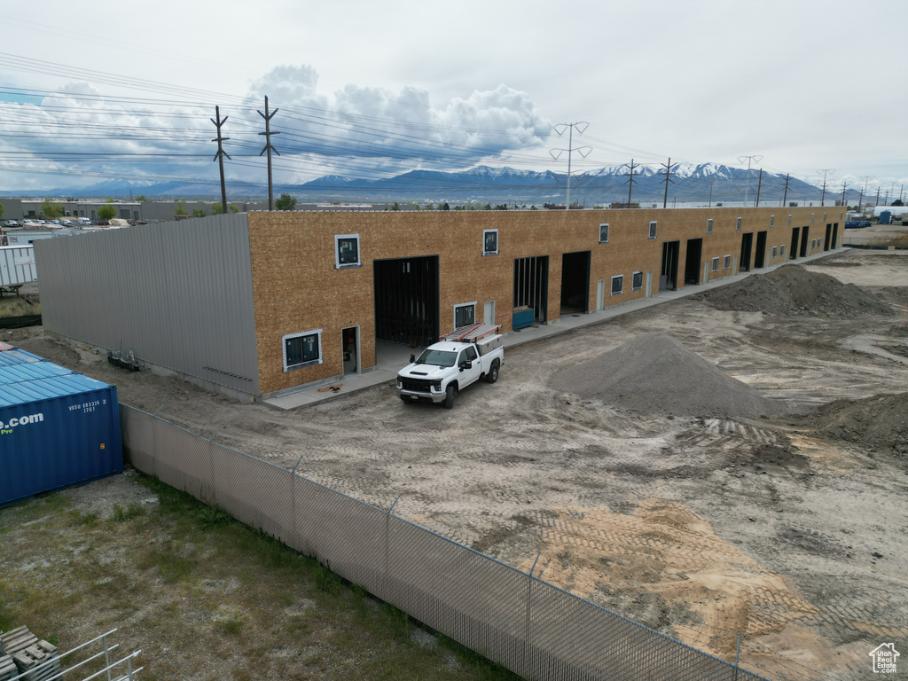 Rear view of house featuring fence and a mountain view