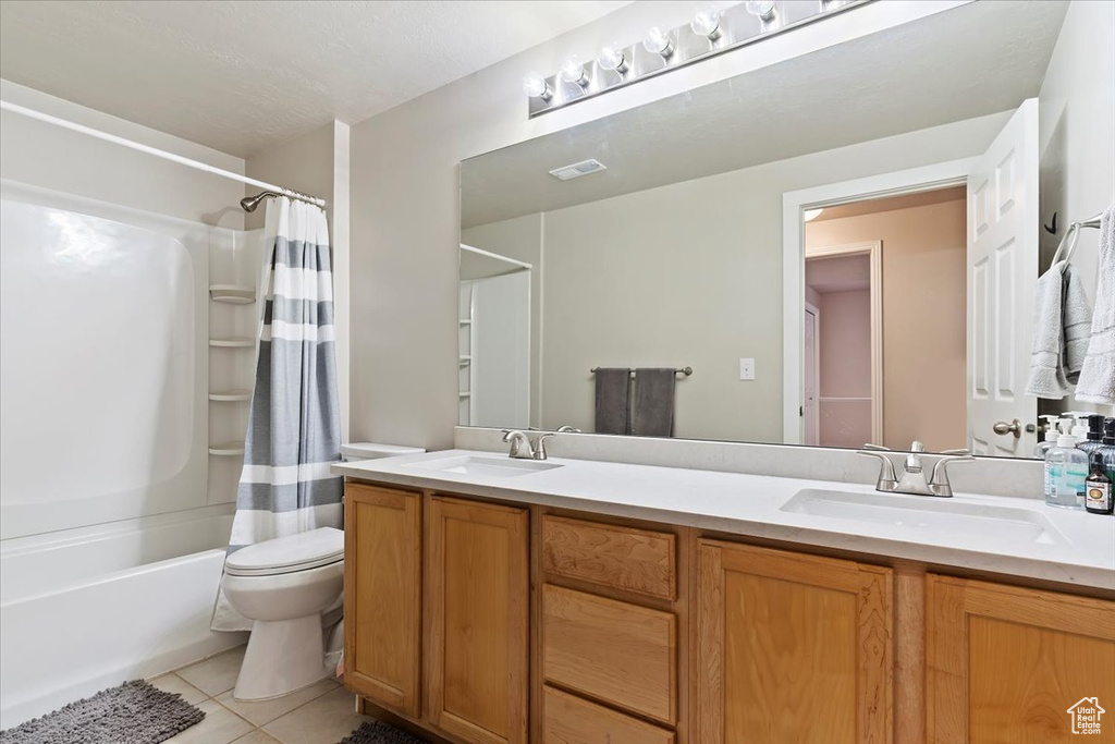 Bathroom with tile patterned floors, visible vents, a sink, and toilet