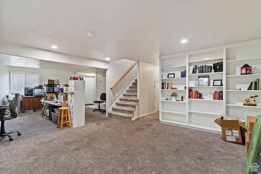 Carpeted home office with recessed lighting and baseboards