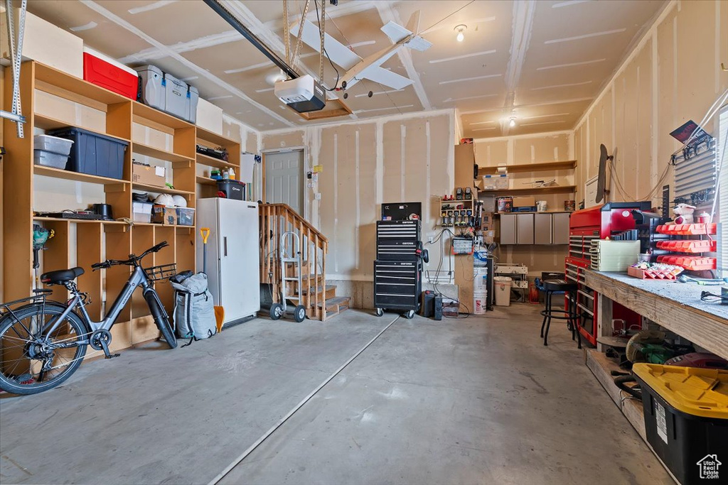 Garage with a workshop area and a garage door opener