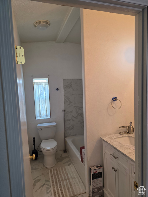 Bathroom featuring vanity, a washtub, toilet, and marble finish floor