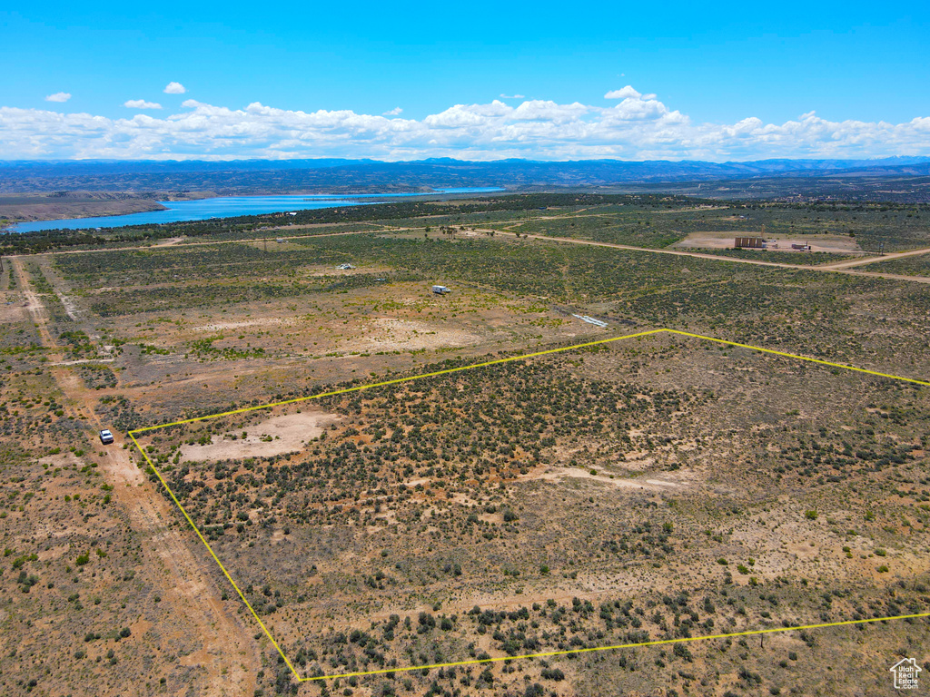 Aerial overview of property's location featuring property boundaries highlighted and a water and mountain view