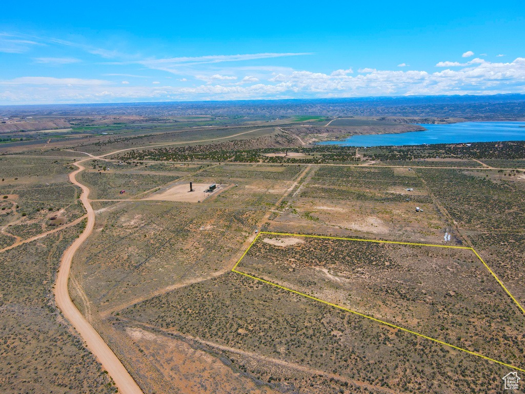 Overview of rural landscape with property parcel outlined and a large body of water