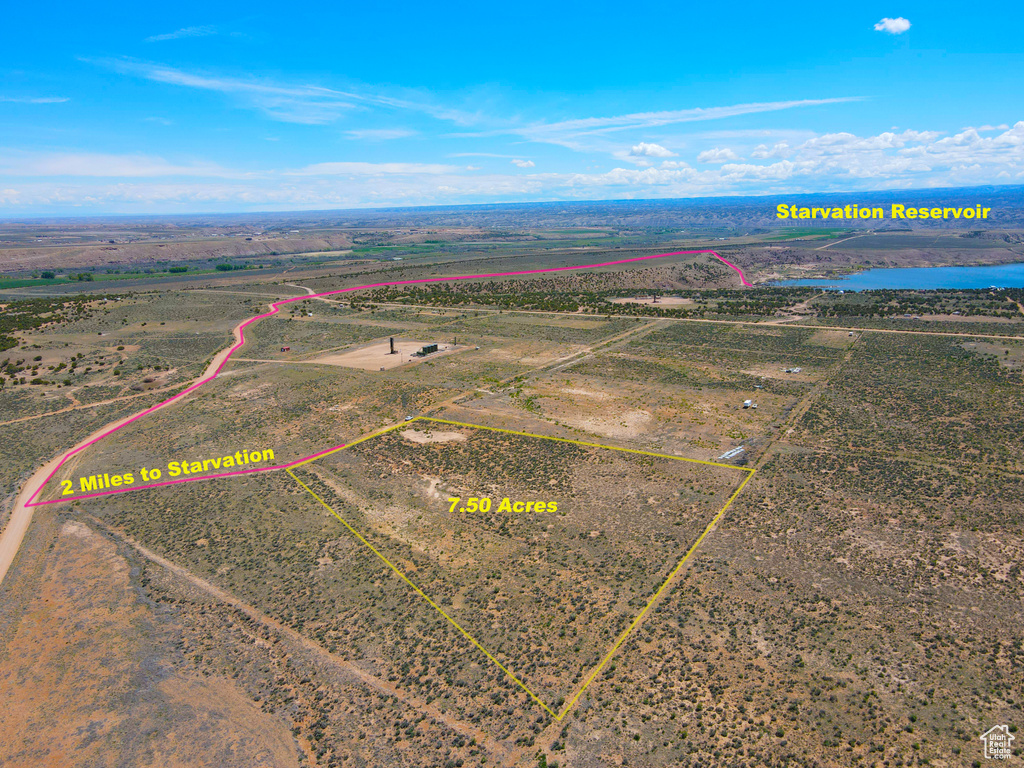 View of rural area featuring property parcel outlined and a nearby body of water