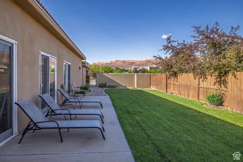View of yard featuring a mountain view, a fenced backyard, and a patio area